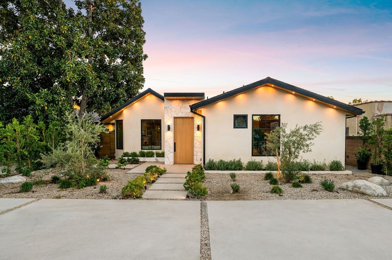 Modern single-story home exterior with minimalist landscaping at sunset