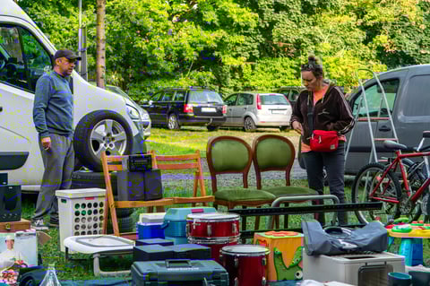 Flea market display of chairs, drums, radio player and bicycle